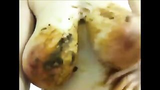 Sexy wife smearing shit on her natural boobs