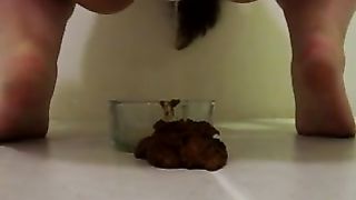 woman defecates in small cup