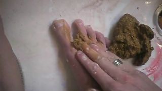 playing with her poop