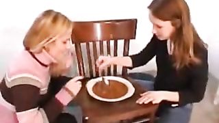 two girls playing with a plate full of shit