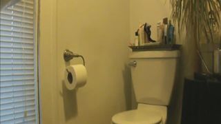 brunette pooping on the toilet having a hard time