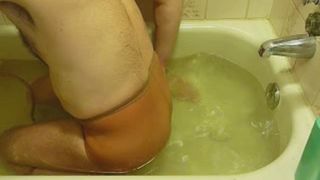 man pooping in his pants in the bathtub