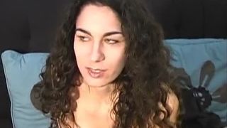 Brunette girl with curly hair puking in a vase