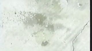 Young girl peeing on a plastic ball