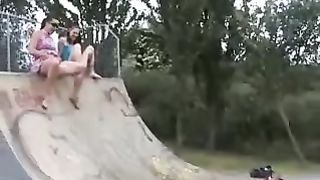 Two girls peeing in a park