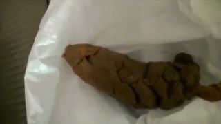 Cute Asian girl pooping on a plastic bag