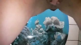 Shaved girl pooping over toilet