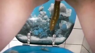 Shaved girl pooping over toilet