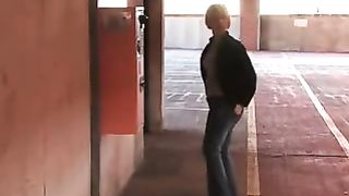 Mature woman peeing on a parking lot