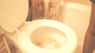 Holding her ass while shitting over toilet