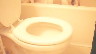 Holding her ass while shitting over toilet