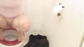 Having fun while shitting over toilet
