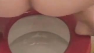 Having fun while shitting over toilet