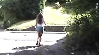 Teasing with her tits while peeing in public