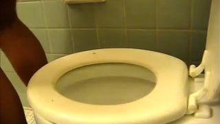 Ebony babe shitting over toilet