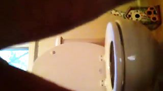 Ebony beauty pooping in toilet