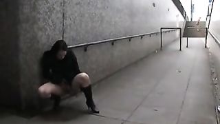 Hot brunette peeing in an underpass