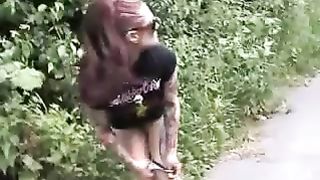 Rocker girls peeing behind bushes