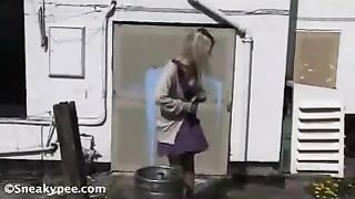 Busty blonde peeing in a bucket