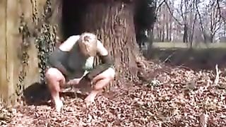 Emo girl peeing behind a tree