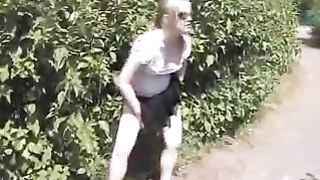 Blonde teen peeing on the side of the road