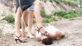 Two blonde sluts peeing on a male slave