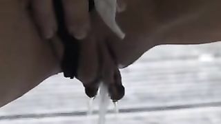 Blonde hottie peeing on a wooden bridge