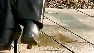 Two blonde girls peeing near footpath