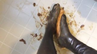 Rubbing shit on her latex feet