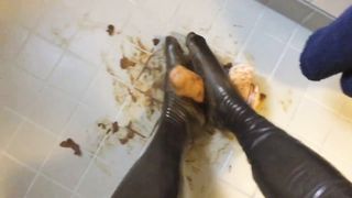 Rubbing shit on her latex feet
