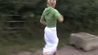 Blonde milf peeing on a rock