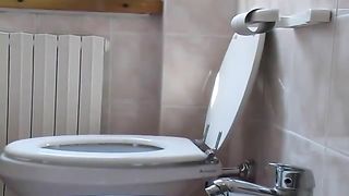 Curvy wife shitting in toilet