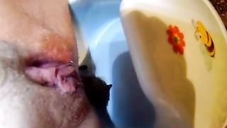 Shaved girl pooping in baby potty