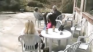 Two girls peeing on a plastic table