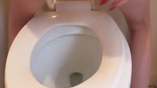 Shaved girl shitting in toilet