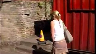 Hot blonde peeing in courtyard