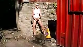 Hot blonde peeing in courtyard