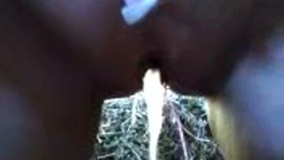 Fat girl peeing on a field