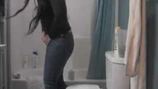 Dark haired babe farting while pooping