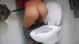 Young girl shitting over toilet