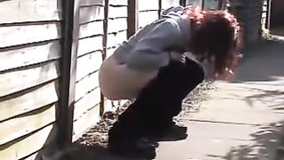 Redhead babe peeing in public
