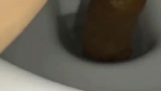 Shaved girl pooping in toilet