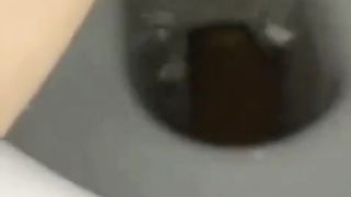 Shaved girl pooping in toilet