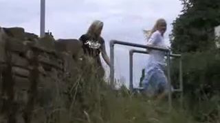 Two blonde girls peeing by turn