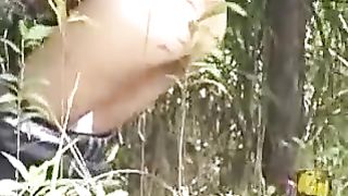 Slim girl shitting in a park