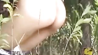 Slim girl shitting in a park