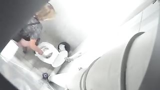 Blonde babe using a public bathroom