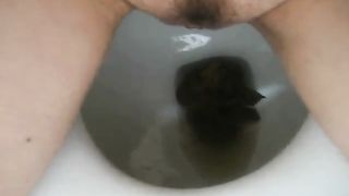 Girl shitting on the toilet