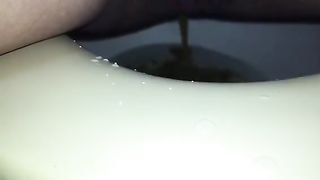 Shaved babe shitting and peeing