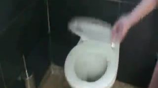 Slim blonde girl shitting in toilet